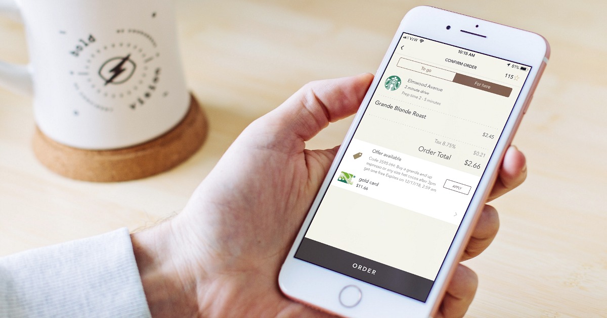 woman holding iphone with starbucks order in app