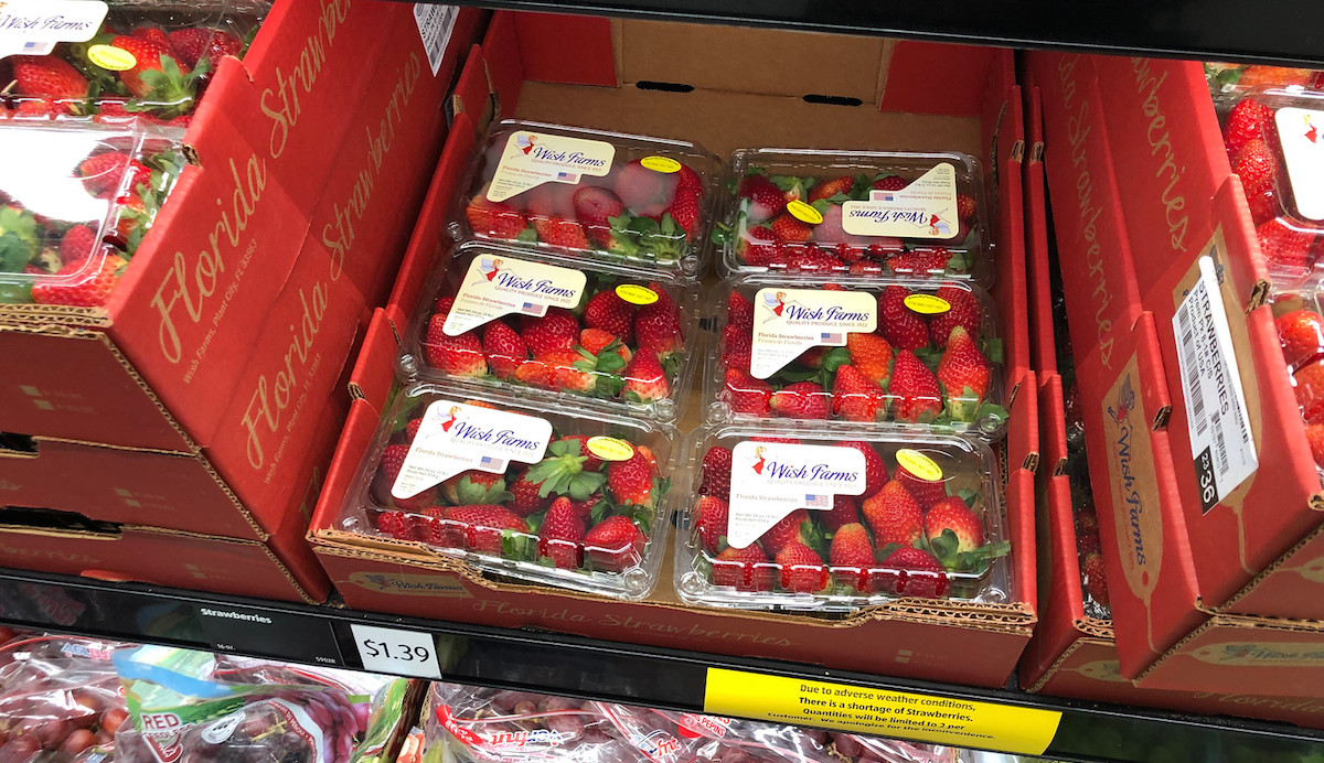 fresh cartoons of strawberries on store shelf