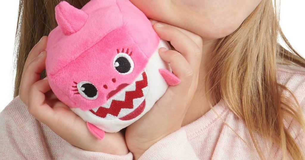 girl holding baby shark song cube mommy shark