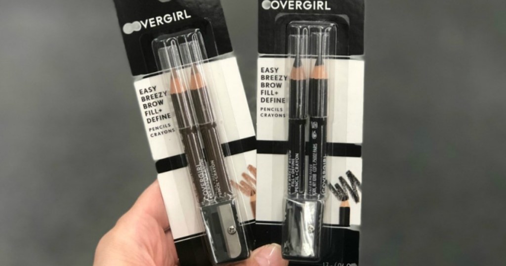 hand holding two packs of CoverGirl Brow Pencils