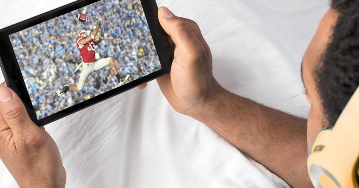 man watching football on a tablet