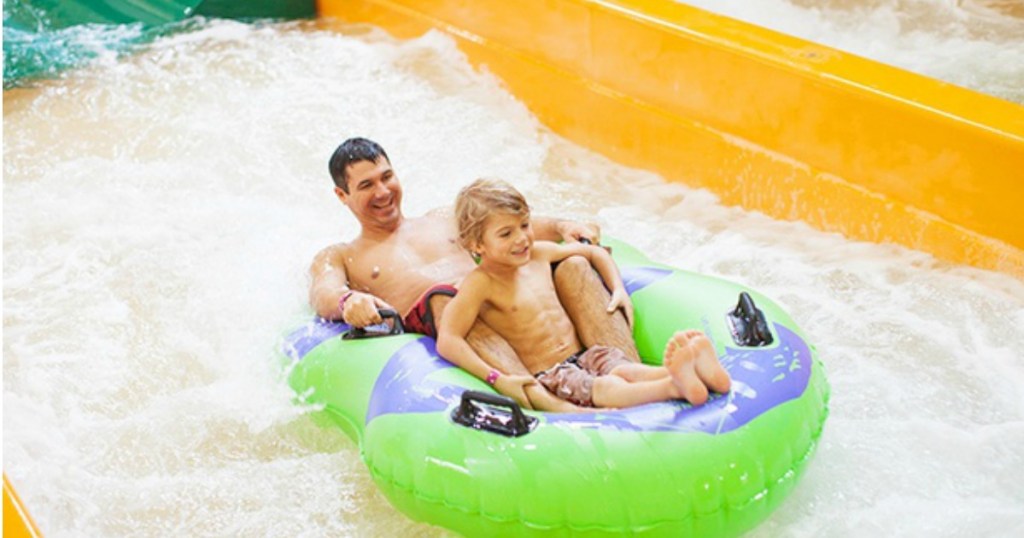 dad and son in tube in water slide 