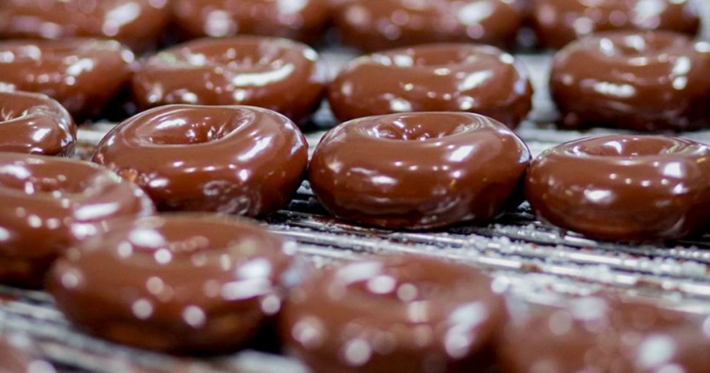 chocolate glazed Krispy Kreme doughnuts on a rack