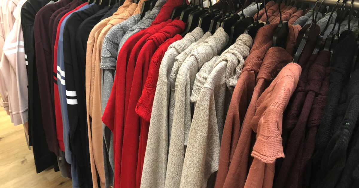 in store photo of sweaters hanging on a rack