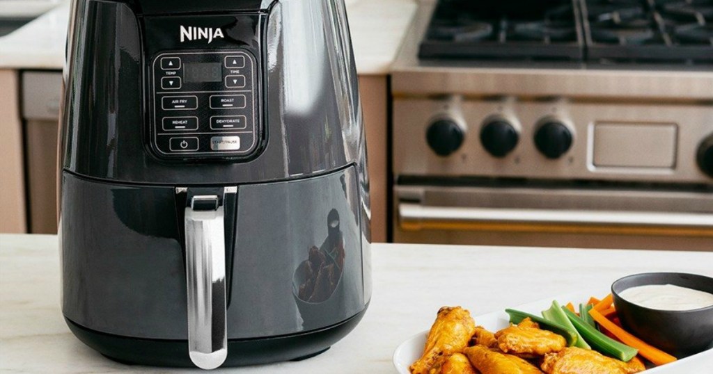 Ninja 4-Quart Air Fryer on kitchen counter with plate of chicken wings
