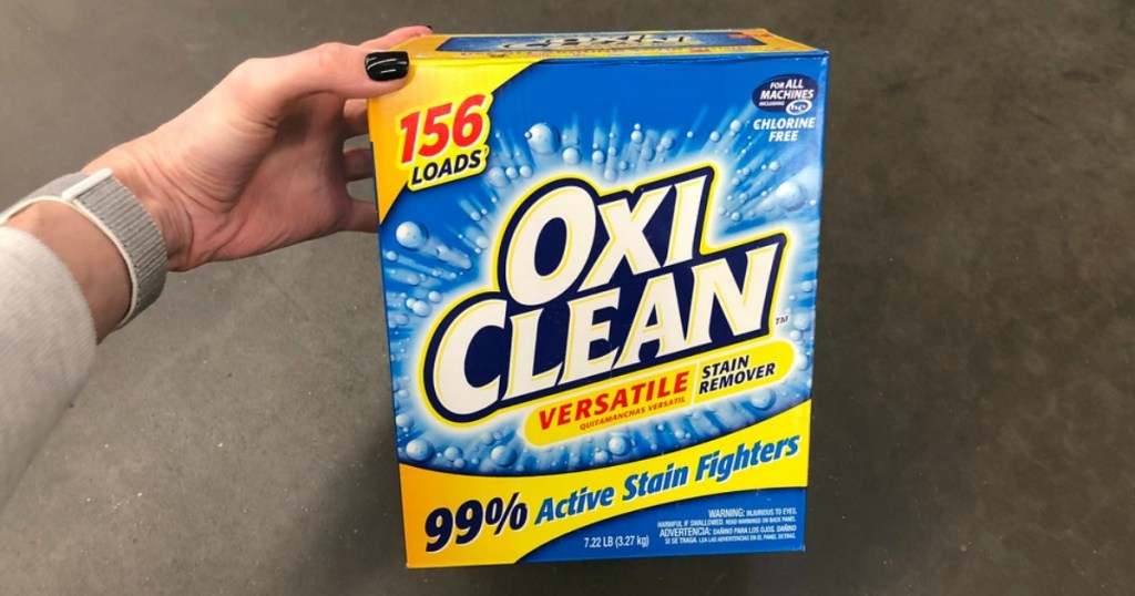woman holding a box of oxiclean
