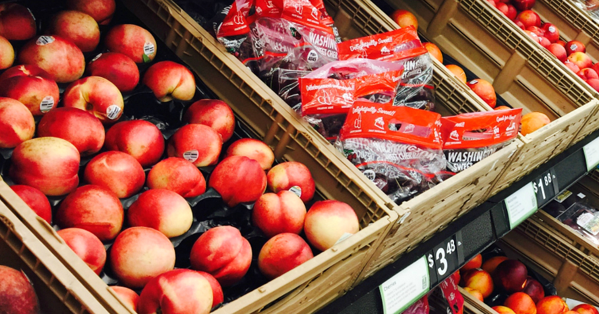 Fresh peaches in a produce display bin