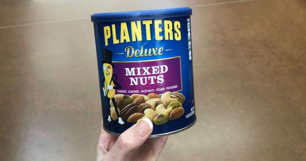 Hand holding Planters Deluxe Mixed Nuts