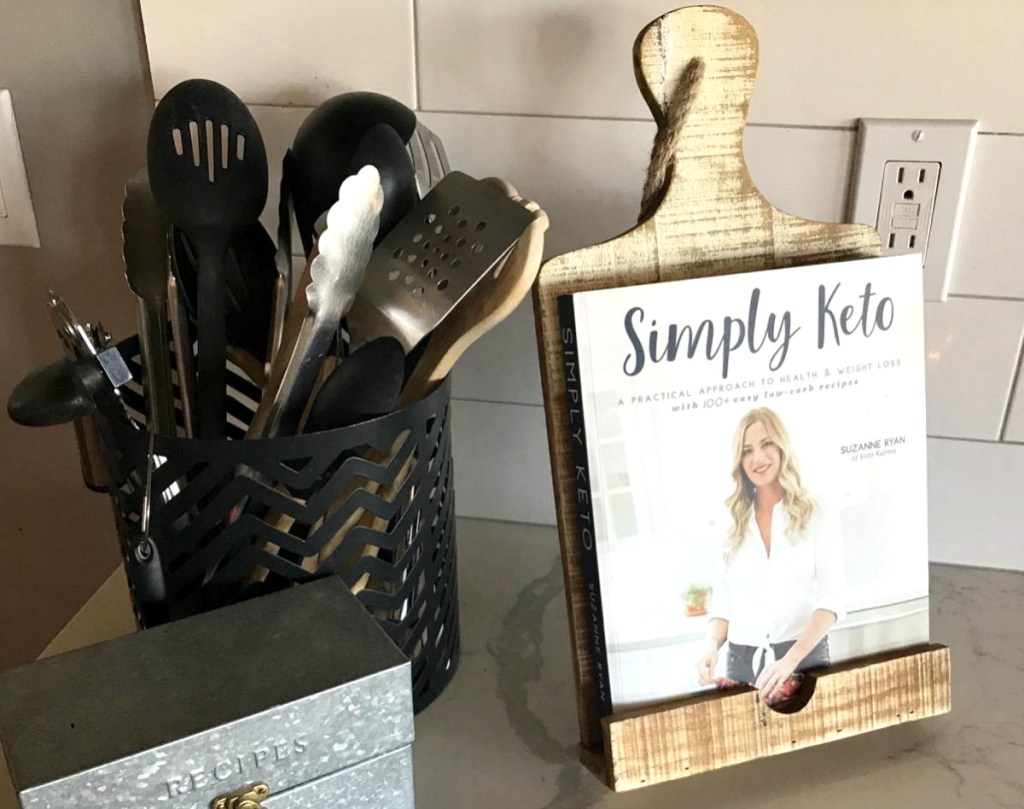 simply keto cookbook on cutting board stand