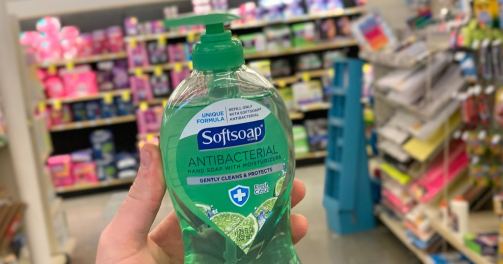 hand holding bottle of antibacterial soap