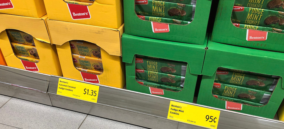 yellow and green stacked cardboard boxes on store shelf full of cookies