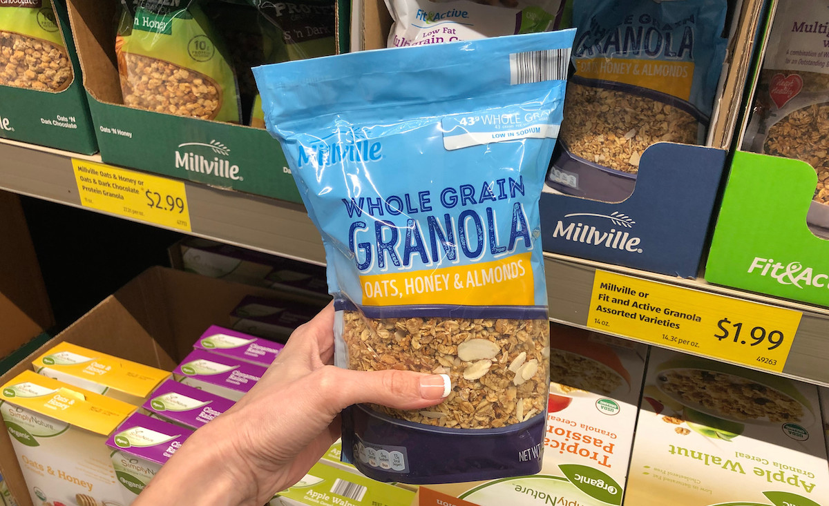 hand holding a bag of whole grain granola 