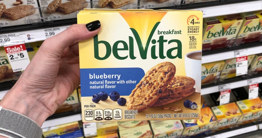 Hand holding up Belvita biscuits