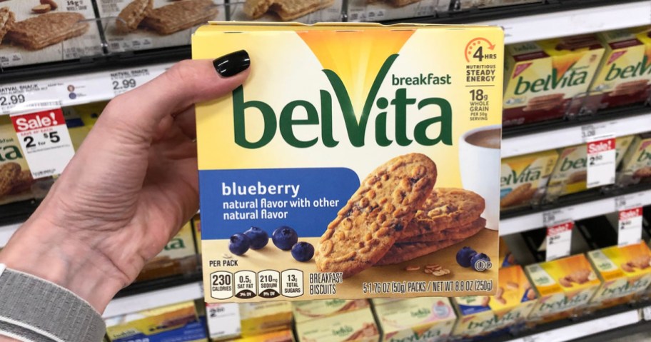 Hand holding up Belvita biscuits