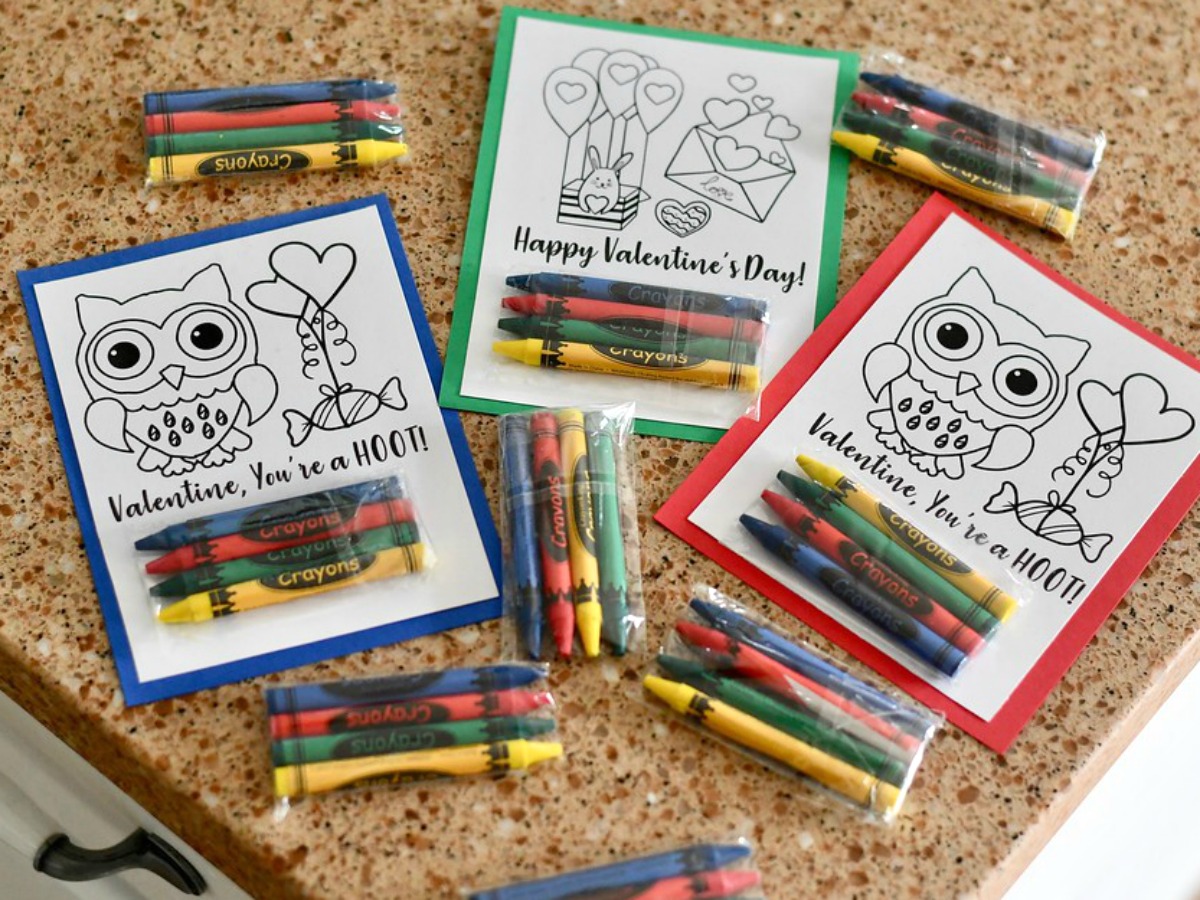 DIY Crayon Valentines (Free Printable Included) – completed Valentines on the counter with extra crayons