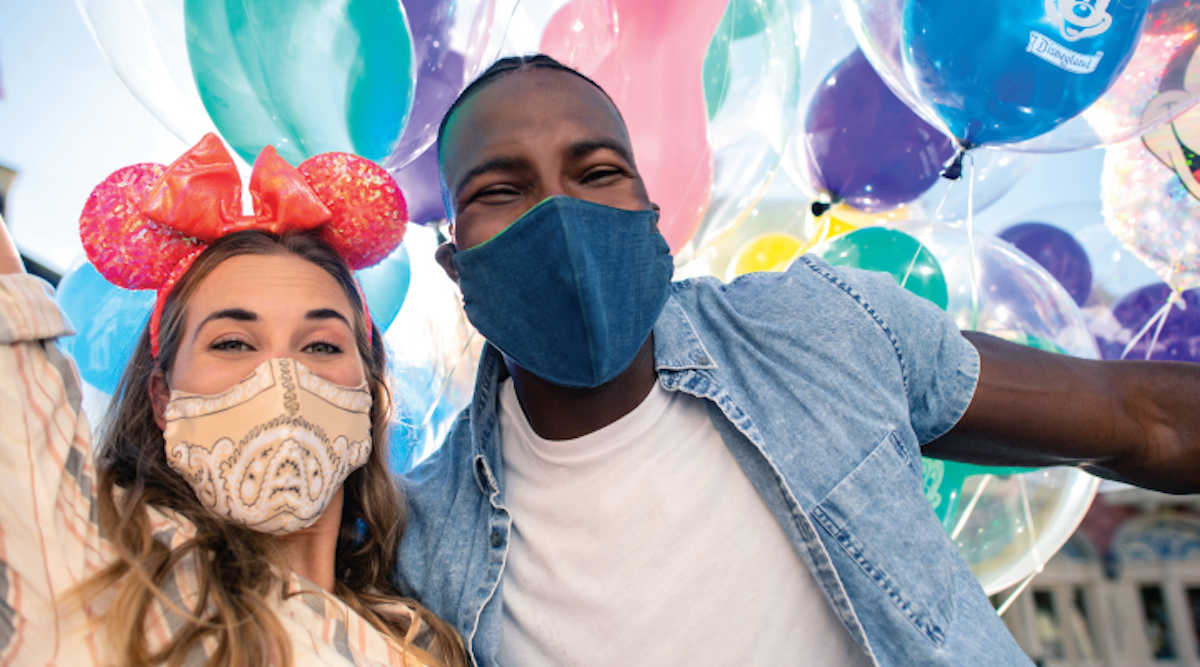 Disneyland balloons and guests with masks from disney discount ticket website