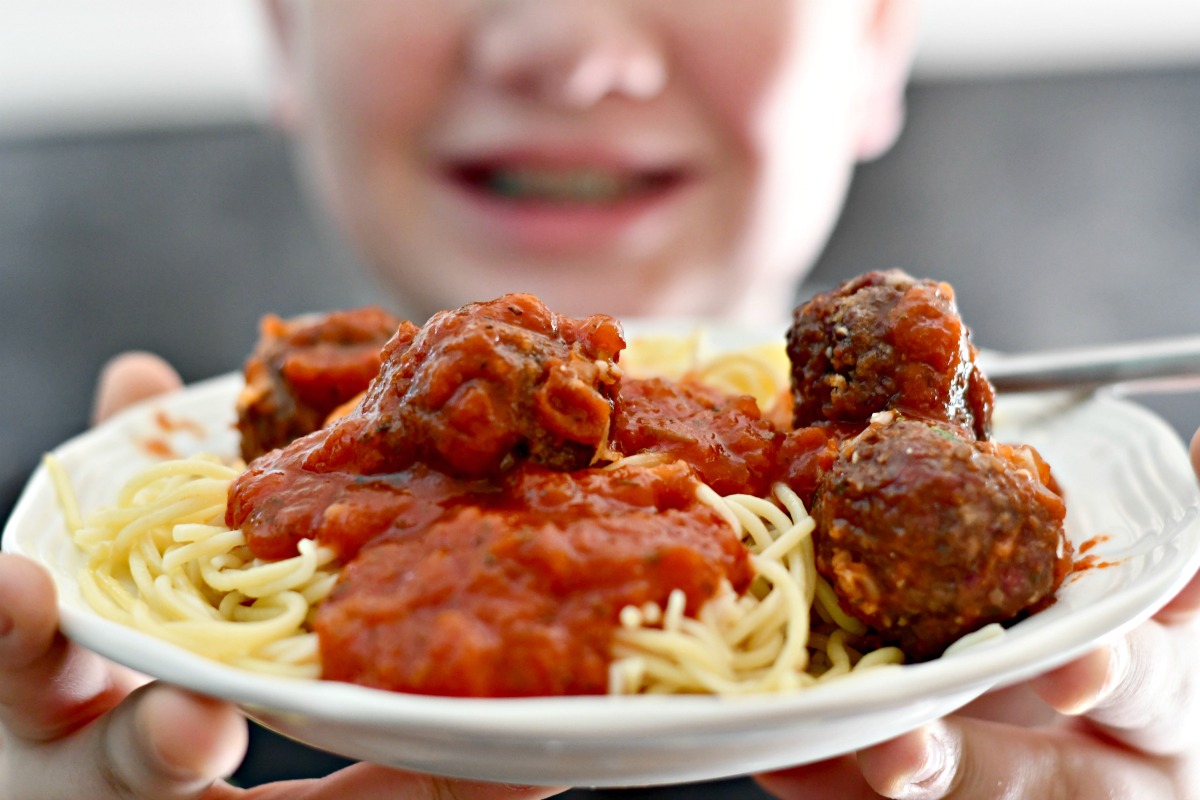 easy air fryer Parmesan meatballs close up on a plate with spaghetti