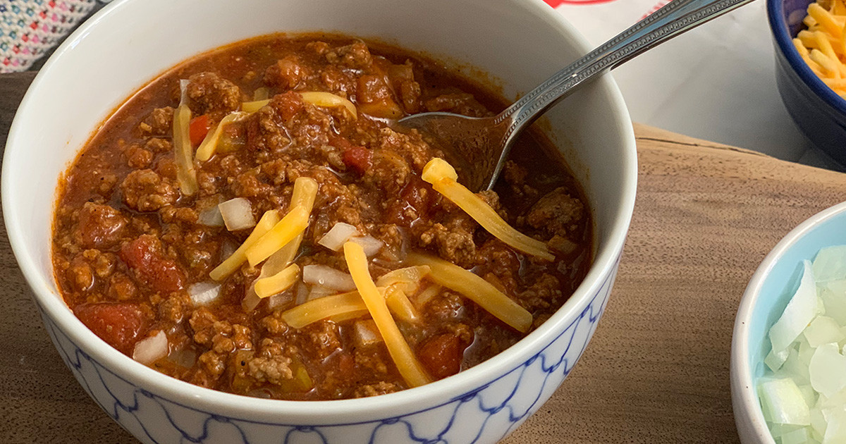 Wendy's Hip2Keto Chili Knock-Off Recipe - up close image of keto chili in a bowl with cheese and onions