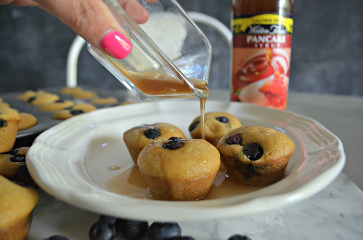 mini pancake bites made keto – pouring sugar-free syrup over bites