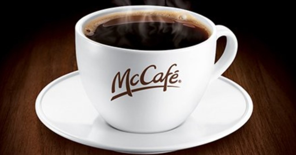 White coffee mug full of coffee with McCafe logo printed on it