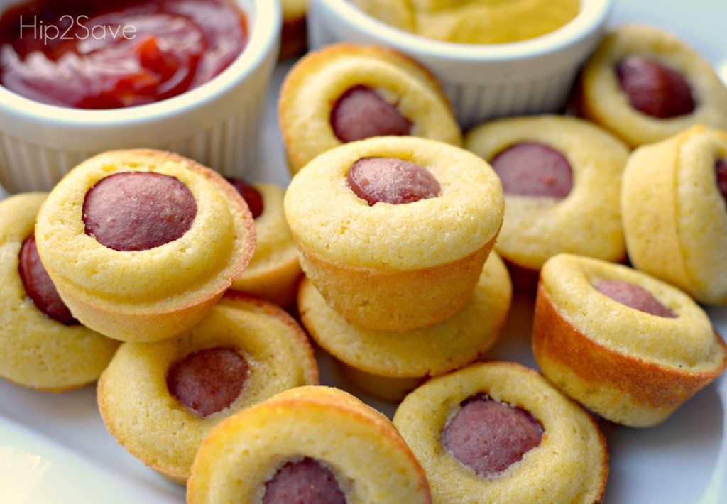 mini corn dog muffins next to bowls of ketchup and mustard