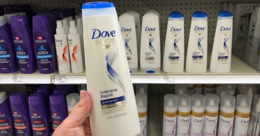 Hand holding Dove Shampoo