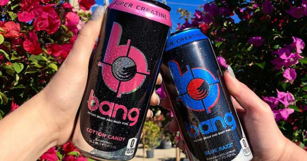two hands holding Bang energy drinks