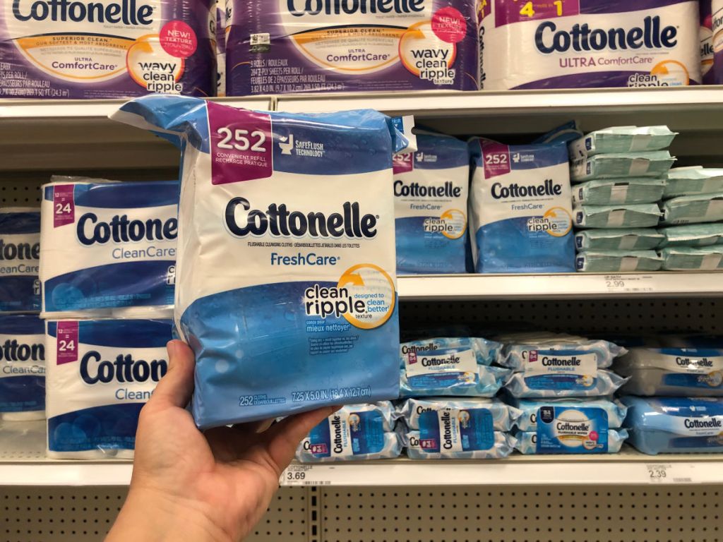 hand holding Cottonelle wipes up in a store 