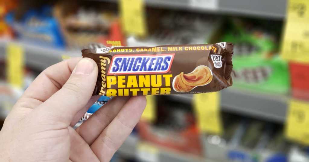 snickers creamy peanut butter bar held in hand