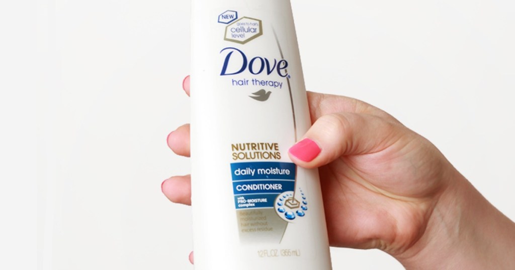 Hand holding Dove Nutritive Solutions Conditioner