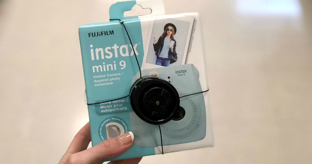 hand holding Instax Fujifilm mini camera