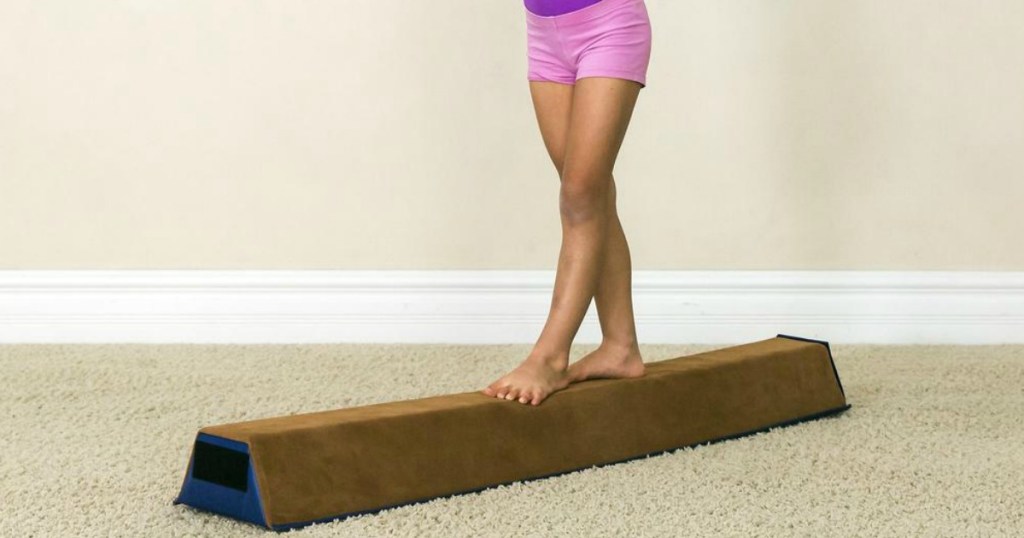 girl walking on a balance beam