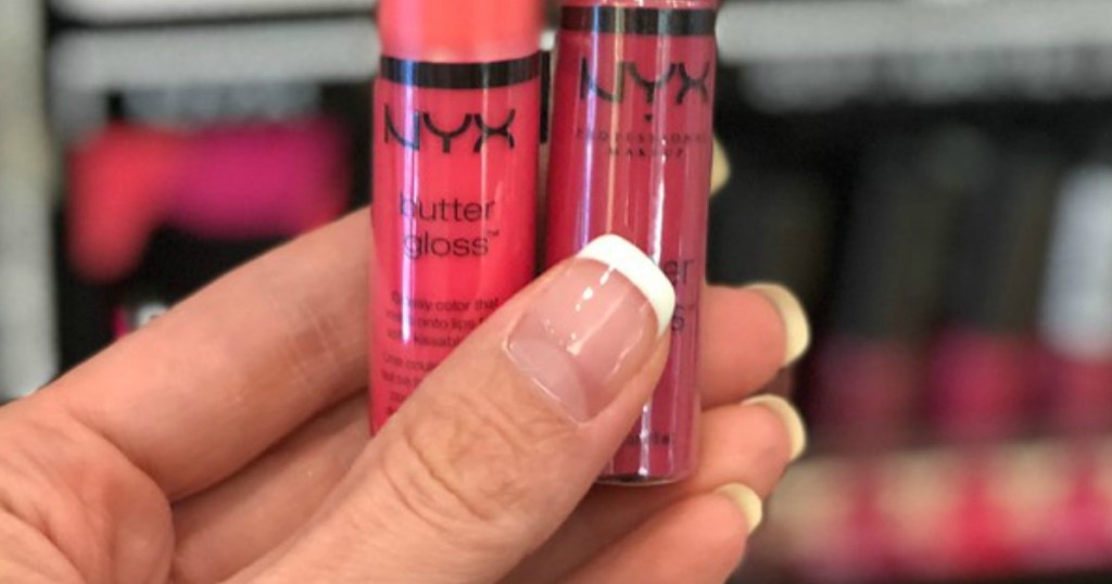 hand holding two NYX Butter Glosses