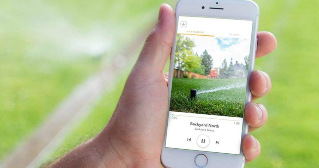 person holding a phone using the Rachio Sprinkler app