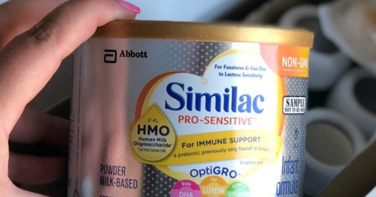 hand holding Similac formula container