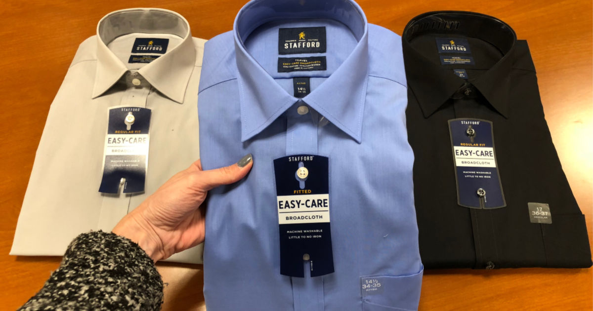 three men's dress shirts laid out on table at store