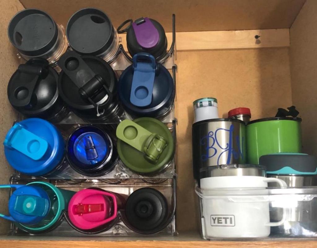 water bottles stacking inside of cabinet on clear organizer