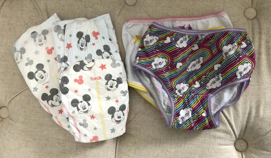 mickey mouse huggies diapers and trolls theme underwear undies still on beige tufted bench