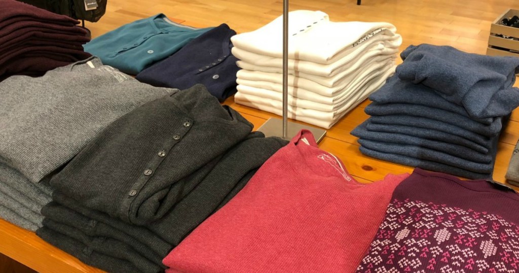 shelf of folded shirts at store on display