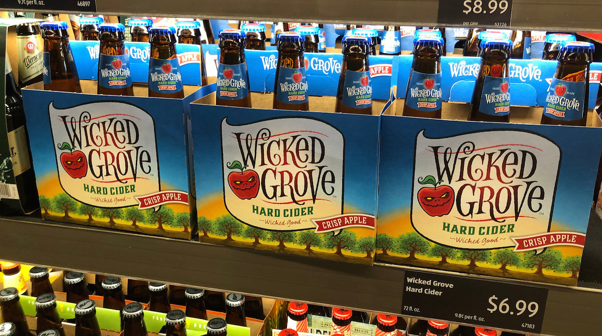 row of six packs wicked grove hard cider bottles alcoholic beverages
