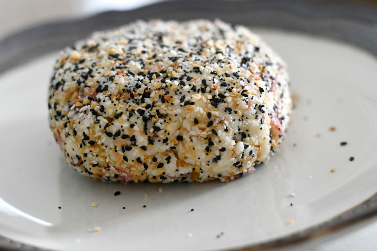 everything but the bagel seasoning cream cheese ball shaped on a plate