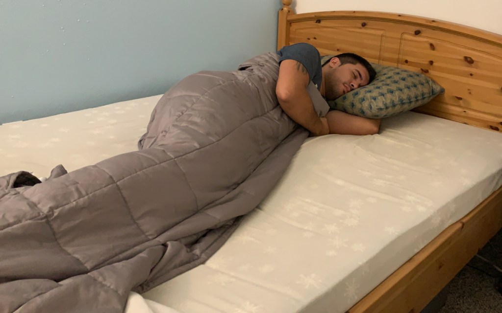 man with amazon weighted blanket