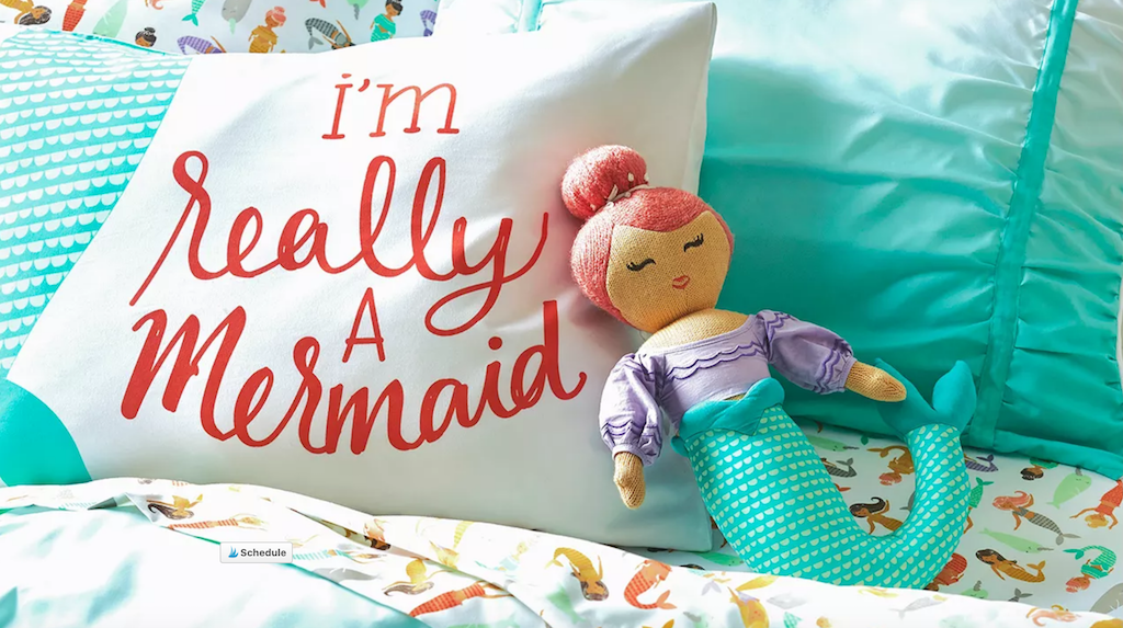 Mermaid throw pillow on bed 