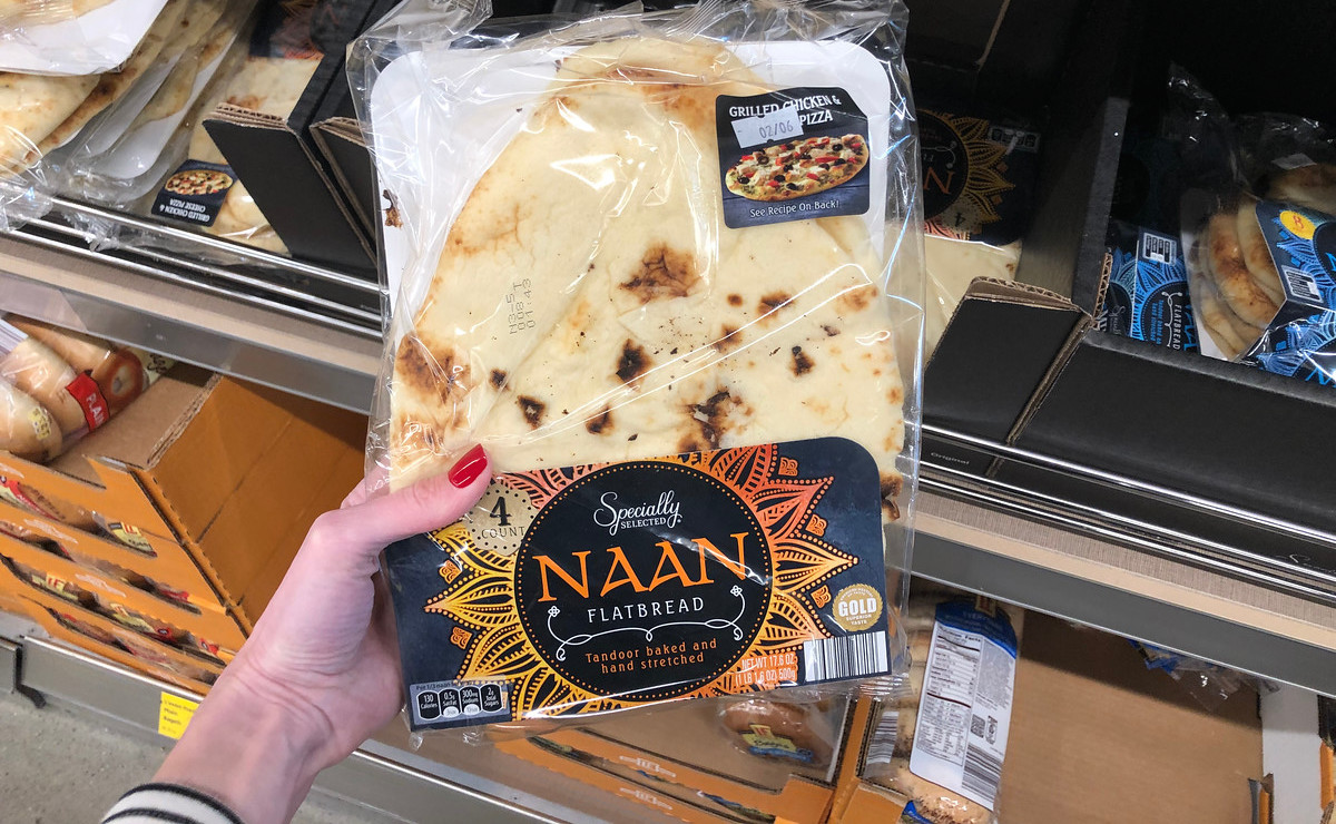 hand holding a package of naan bread 