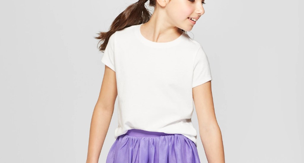 girl wearing a white shirt and purple skirt