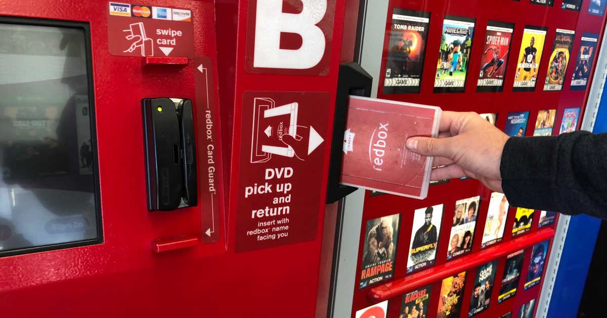 Person returning a disc to Redbox machine