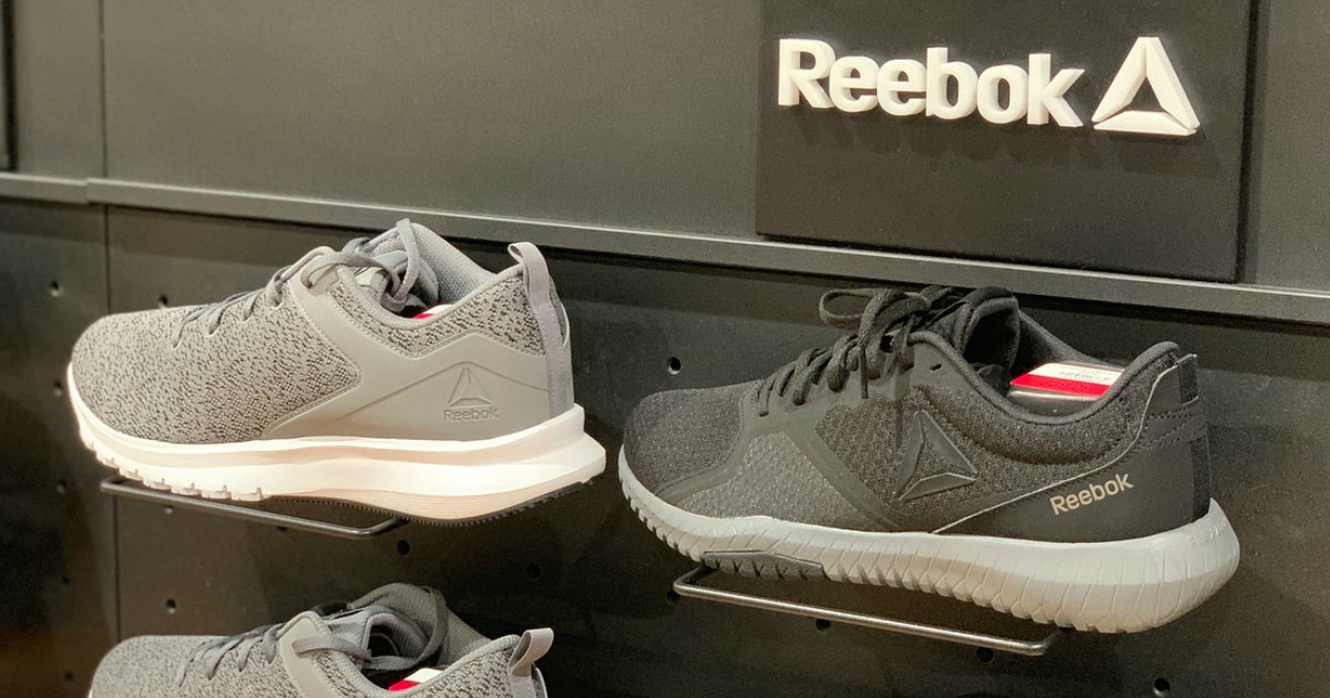 Reebok mens and womens shoes on shelf with Reebok sign