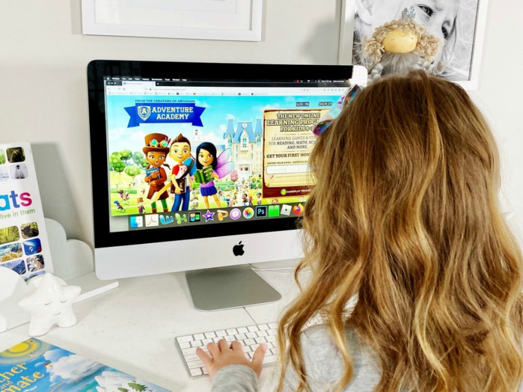 person on computer with Adventure Academy on screen