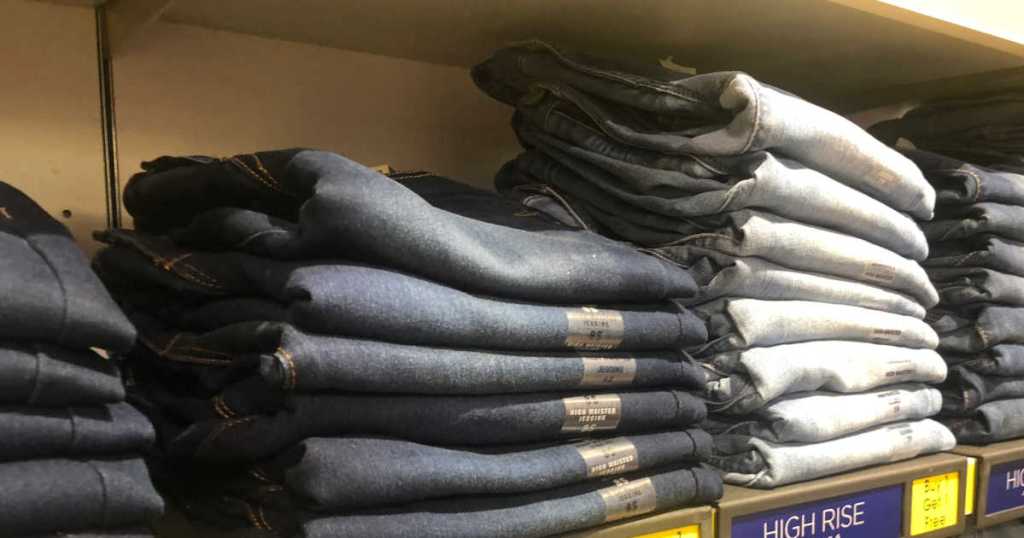 stack of jeans on shelf