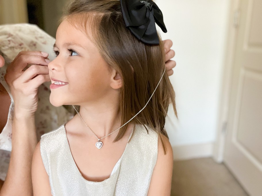 Child wearing Amora heart shaped pendant necklace